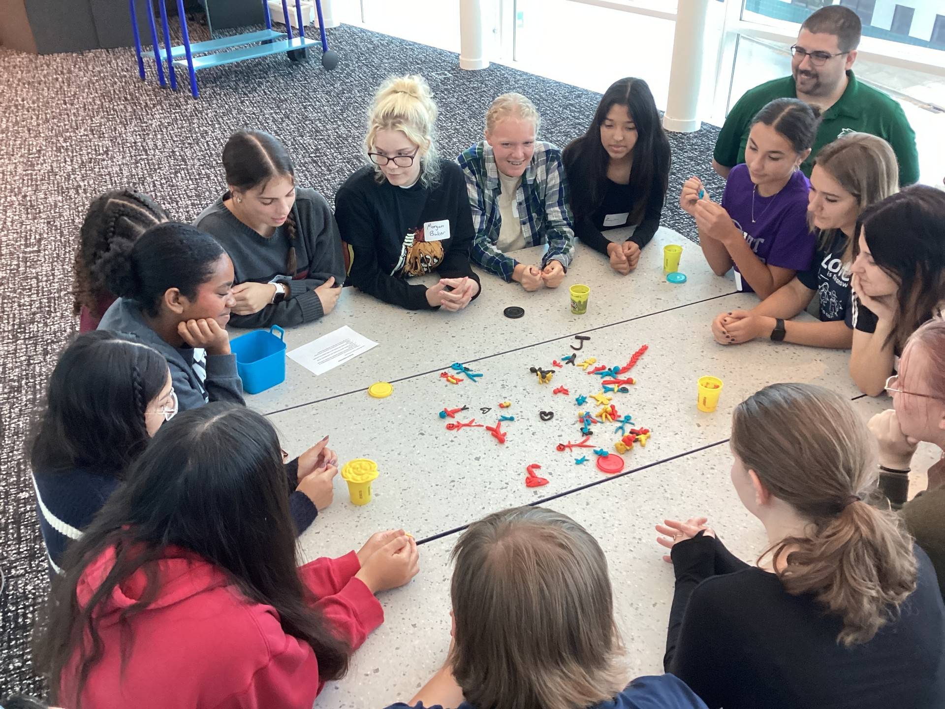 School students engage in group activity with Play-Doh